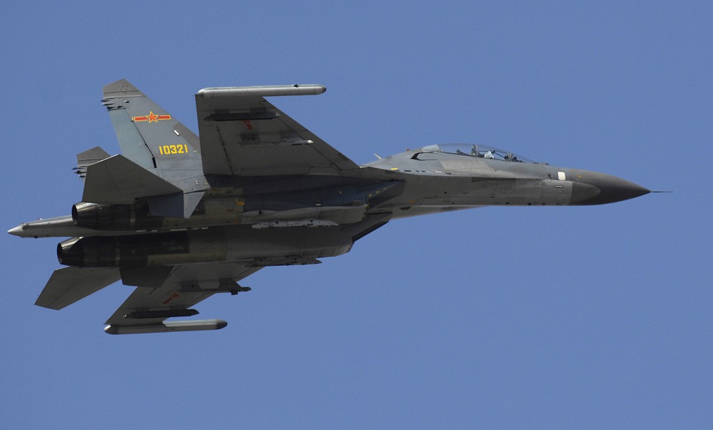 A Chinese Su-27 Flanker fighter makes a fly by while the Chairman of the Joint Chiefs of Staff, Marine Gen. Peter Pace, visits with members of the Chinese Air Force at Anshan Airfield, China Mar. 24, 2007. DoD photo by Staff Sgt. D. Myles Cullen (released)